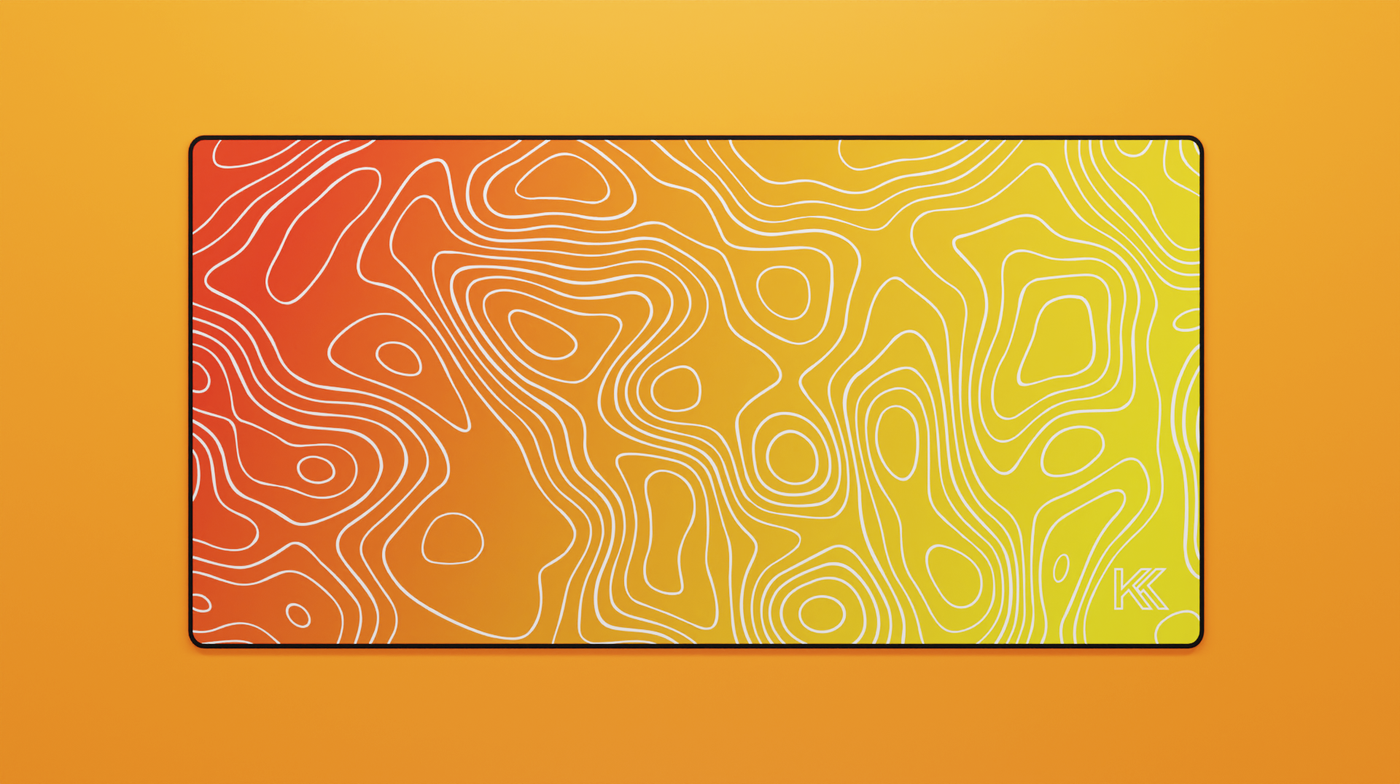 Full view of the Amber Topography Deskmat showing a smooth orange-to-gold gradient with white topographic contour lines and hemmed edges.
