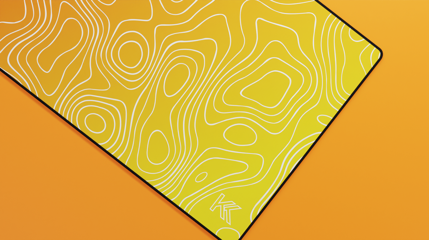 Close-up of the right side of the Amber Topography Deskmat highlighting golden hues, smooth fabric finish, and contour line design.