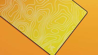 Close-up of the right side of the Amber Topography Deskmat highlighting golden hues, smooth fabric finish, and contour line design.