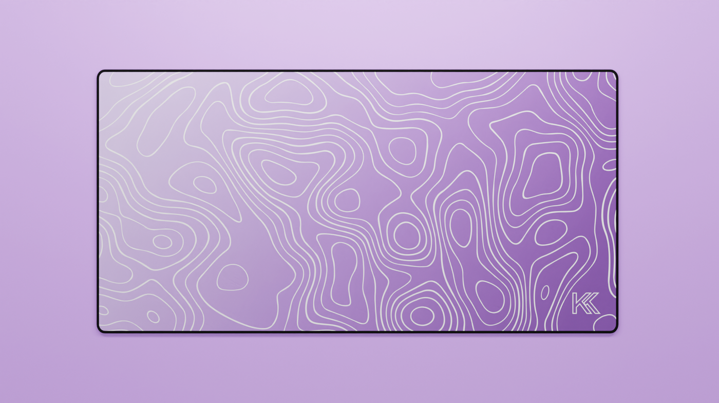 Full view of the Amethyst Topography Deskmat featuring a smooth gradient of deep purple to lilac with white contour lines and black stitched edges.
