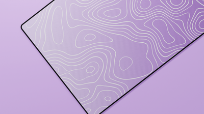 Close-up of the left side of the Amethyst Topography Deskmat showcasing darker purple tones, clean white contour lines, and a premium stitched edge.