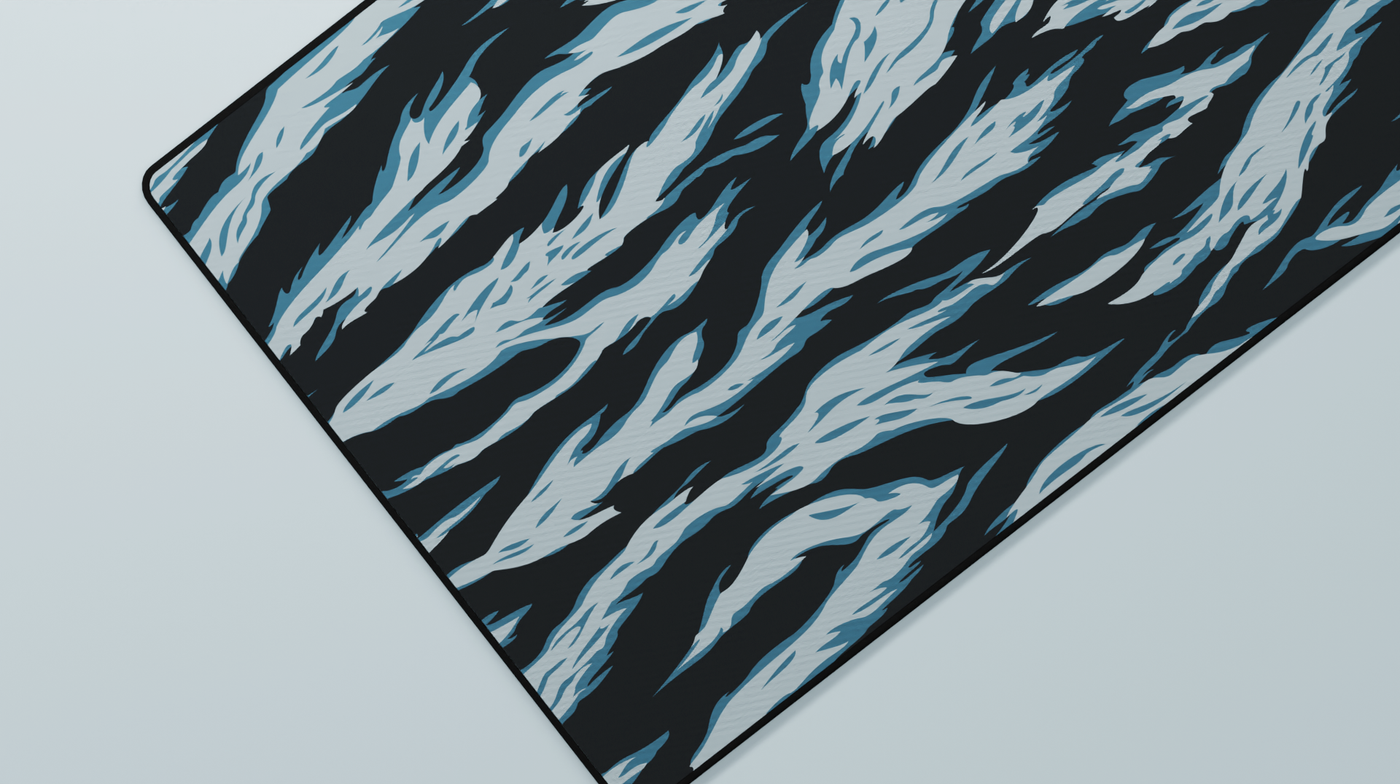 Close-up of the left side of the Avalanche Tiger Camo Deskmat highlighting blueish-teal tiger stripes and smooth neoprene texture.
