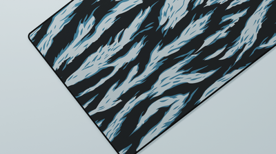 Close-up of the left side of the Avalanche Tiger Camo Deskmat highlighting blueish-teal tiger stripes and smooth neoprene texture.