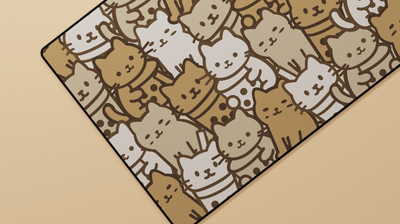 Close-up of the left side of the Boba Cat Deskmat showing adorable neutral-toned cats and boba pattern details on a smooth surface.