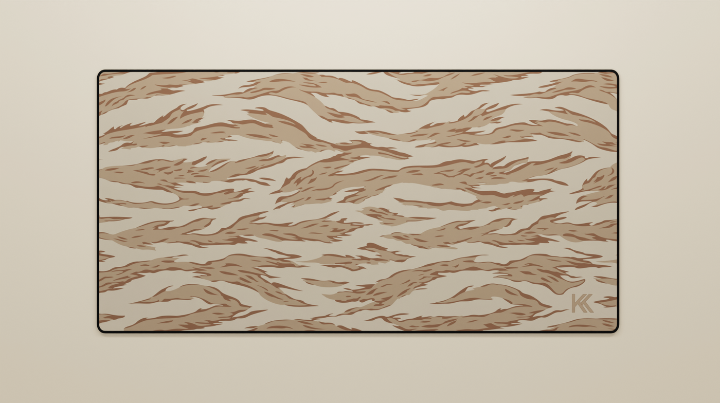 Full view of the Desert Tiger Camo Deskmat showing sandy beige and dark brown tiger stripe camouflage with hemmed edges.