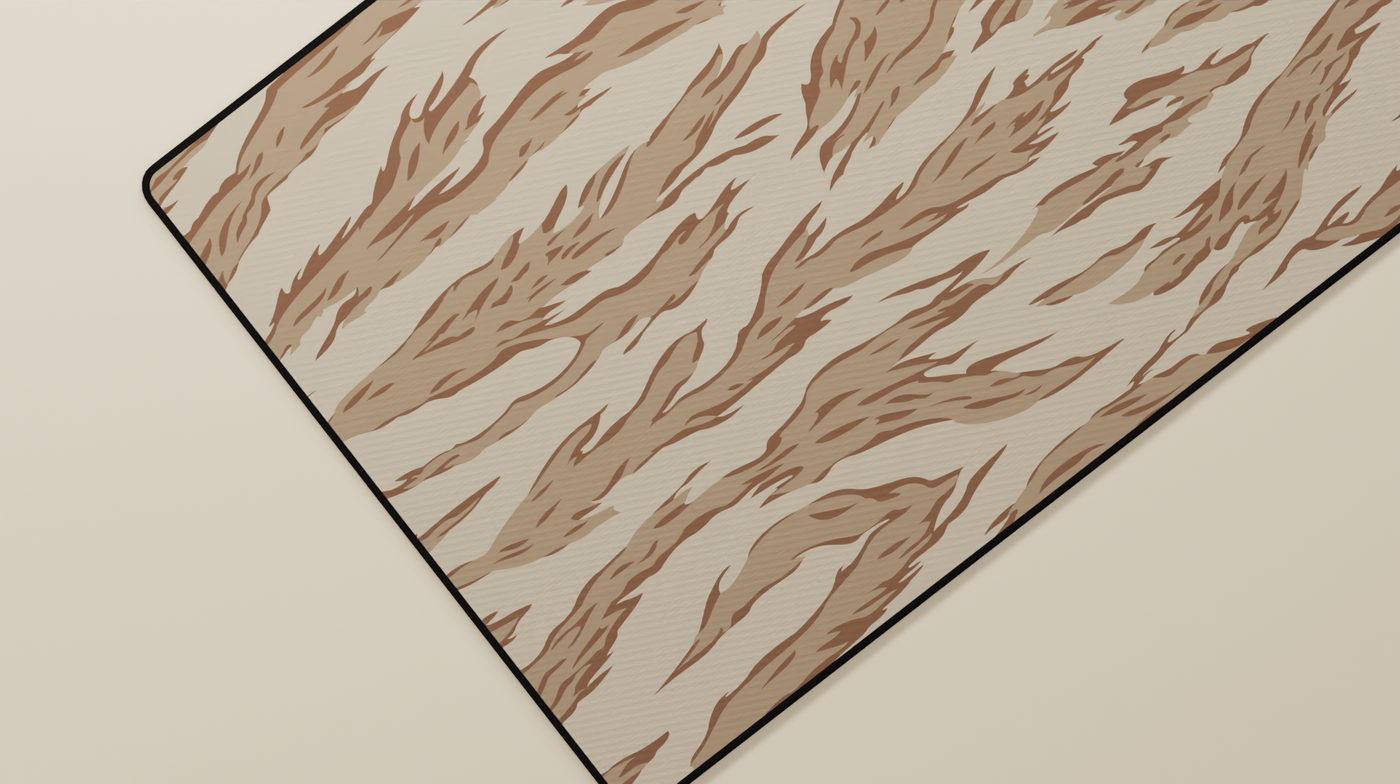 Close-up of the left side of the Desert Tiger Camo Deskmat highlighting beige and brown tiger stripes and smooth neoprene surface.