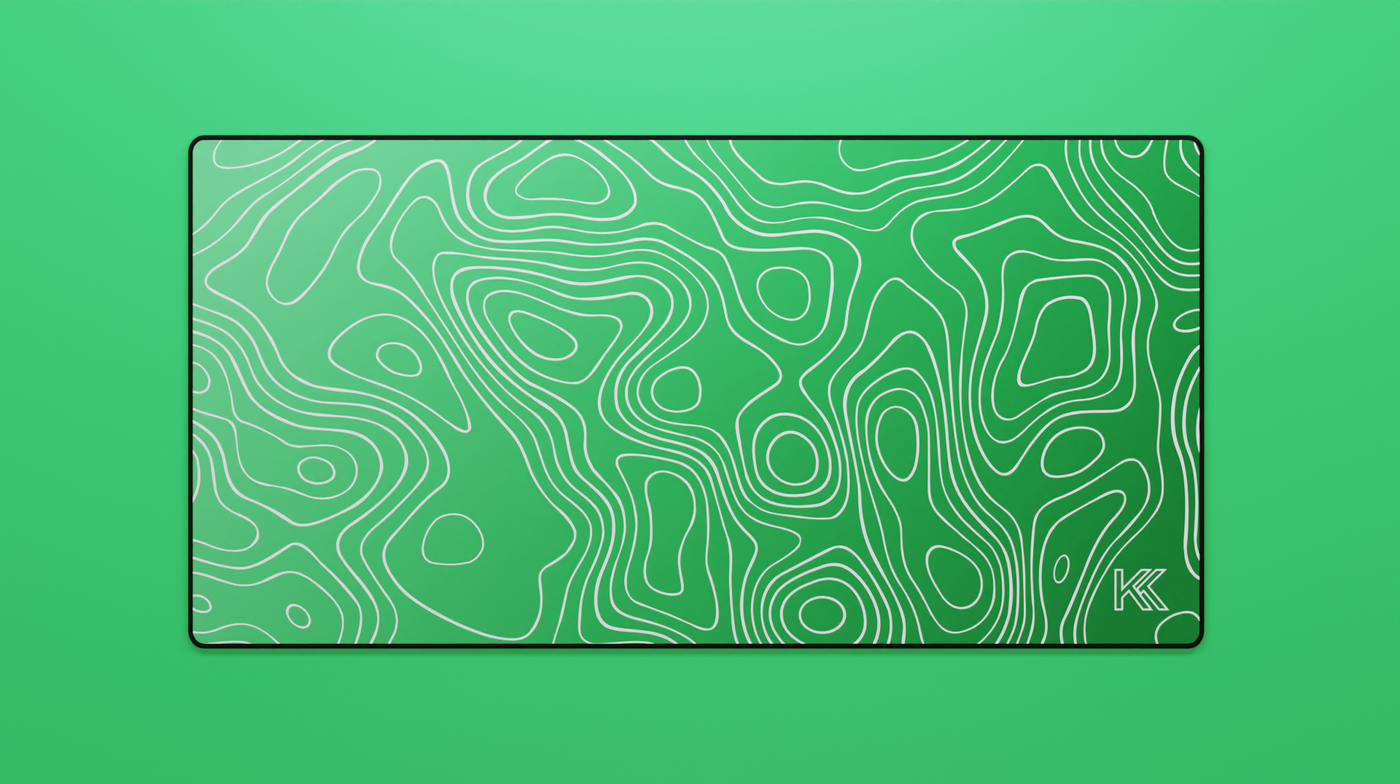 Full view of the Emerald Topography Deskmat featuring a green gradient from emerald to jade with detailed white contour lines and black stitched edges.