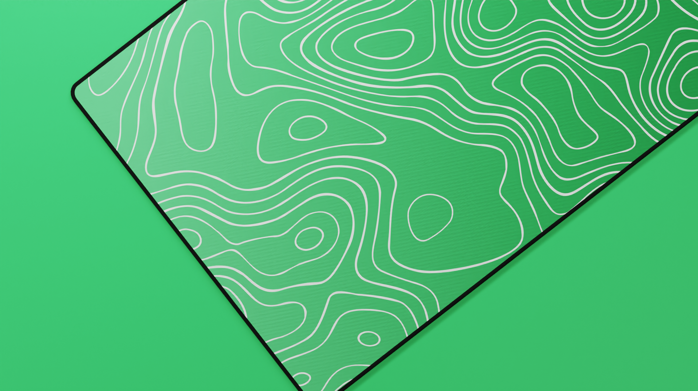 Close-up of the left side of the Emerald Topography Deskmat highlighting deep green tones, contour line texture, and precise hemmed stitching.