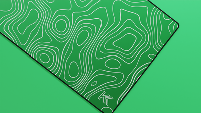 Close-up of the right side of the Emerald Topography Deskmat showcasing lighter jade hues, smooth neoprene texture, and clean stitched edge.