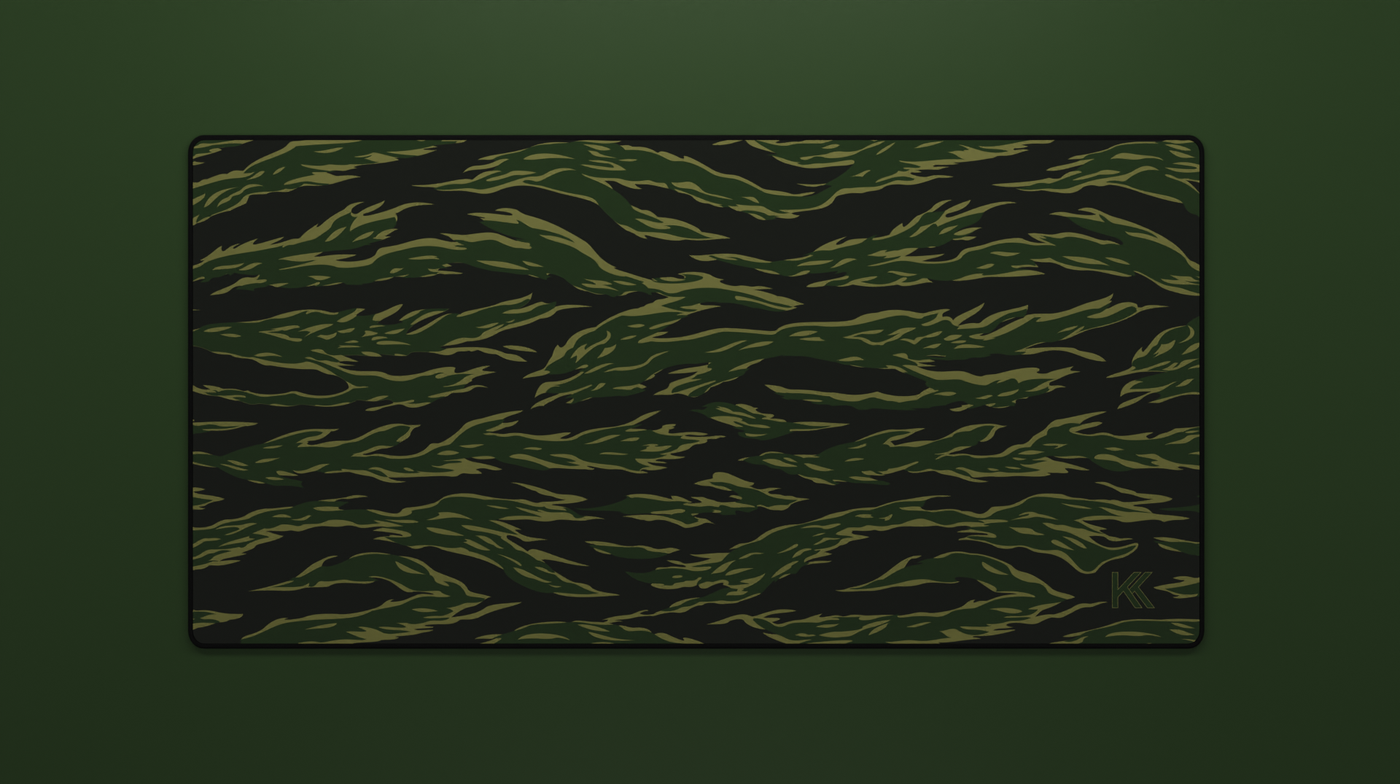 Full view of the Forest Tiger Camo Deskmat showing green and black tiger stripe camouflage with hemmed edges.