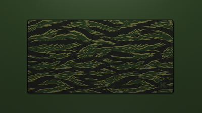 Full view of the Forest Tiger Camo Deskmat showing green and black tiger stripe camouflage with hemmed edges.