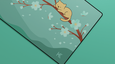 Close-up of the Green Sakura Cat Deskmat featuring the sleeping golden cat on the cherry blossom branch with smooth fabric texture.