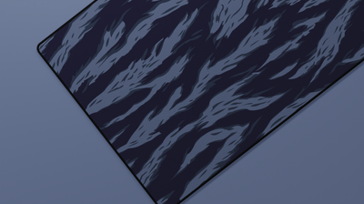 Close-up of the left side of the Ocean Tiger Camo Deskmat highlighting deep blue tiger stripes and smooth neoprene surface.
