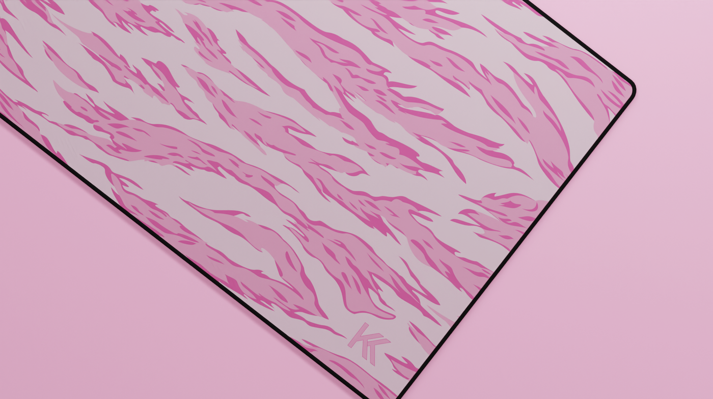 Close-up of the right side of the Pink Tiger Camo Deskmat showing bold stripe pattern, hemmed stitching, and surface texture.