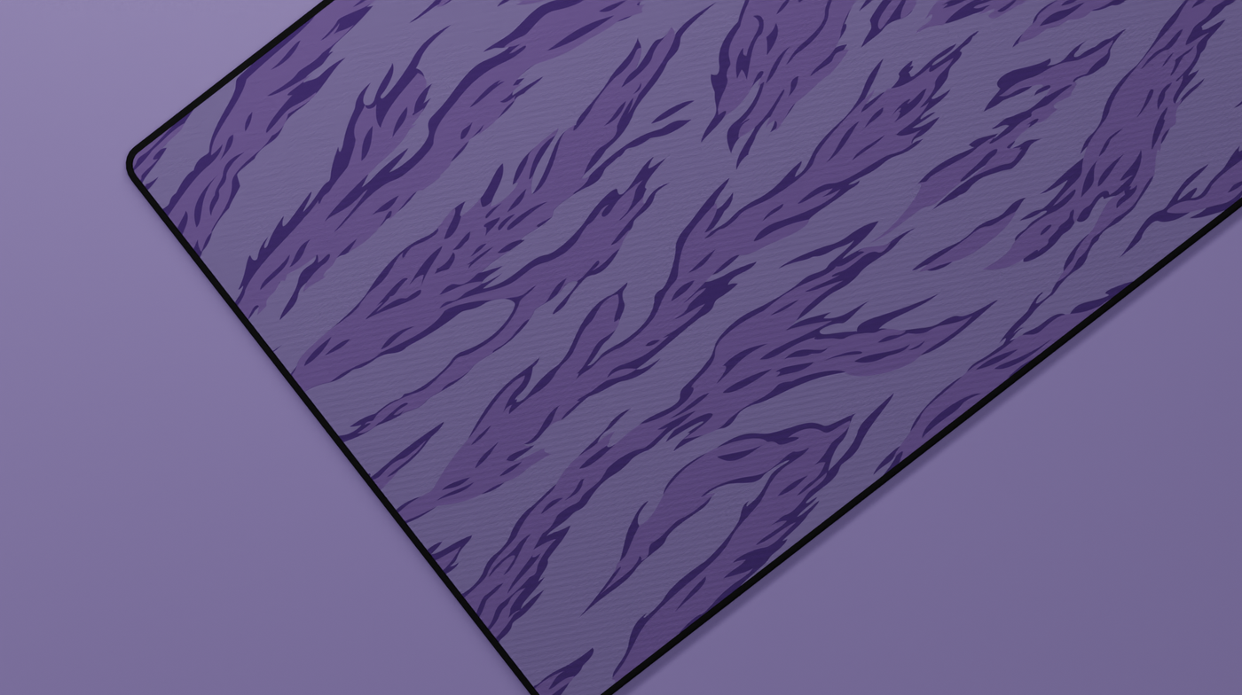 Close-up of the left side of the Purple Tiger Camo Deskmat highlighting vibrant purple tiger stripes and smooth neoprene texture.