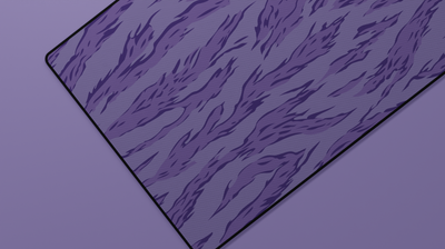 Close-up of the left side of the Purple Tiger Camo Deskmat highlighting vibrant purple tiger stripes and smooth neoprene texture.