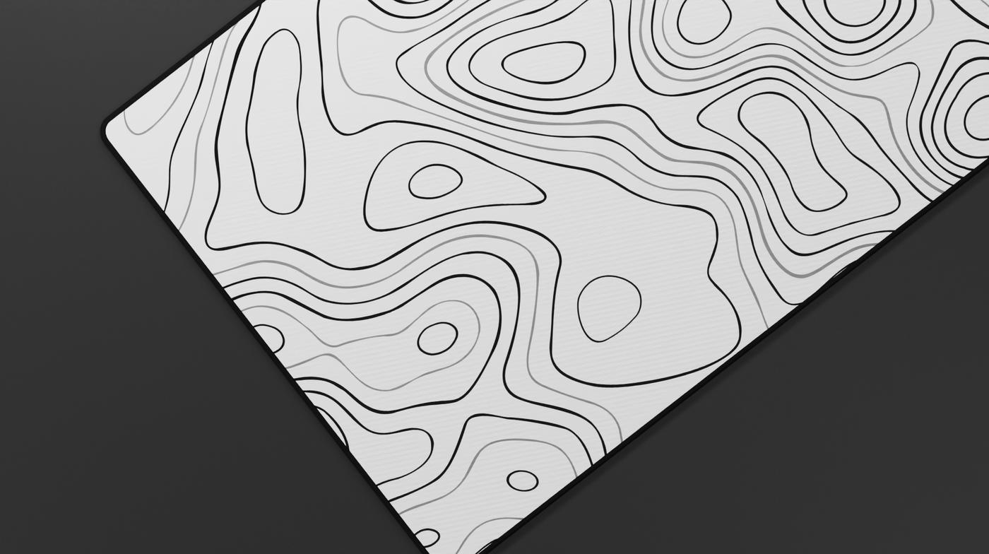 Close-up of the left side of the Quartz Topography Deskmat showing fine white topographic lines and smooth stitched neoprene surface.