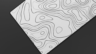 Close-up of the left side of the Quartz Topography Deskmat showing fine white topographic lines and smooth stitched neoprene surface.