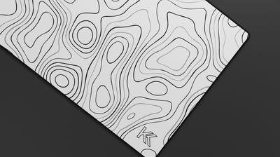 Close-up of the right side of the Quartz Topography Deskmat highlighting soft white tones, clean line detailing, and premium stitching.