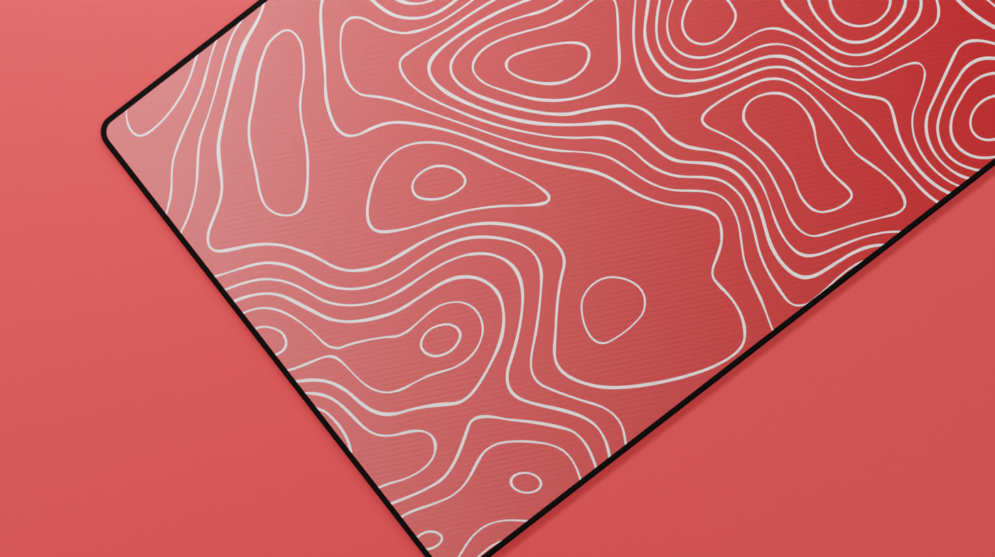 Close-up of the left side of the Ruby Topography Deskmat showing rich red tones and detailed contour lines.