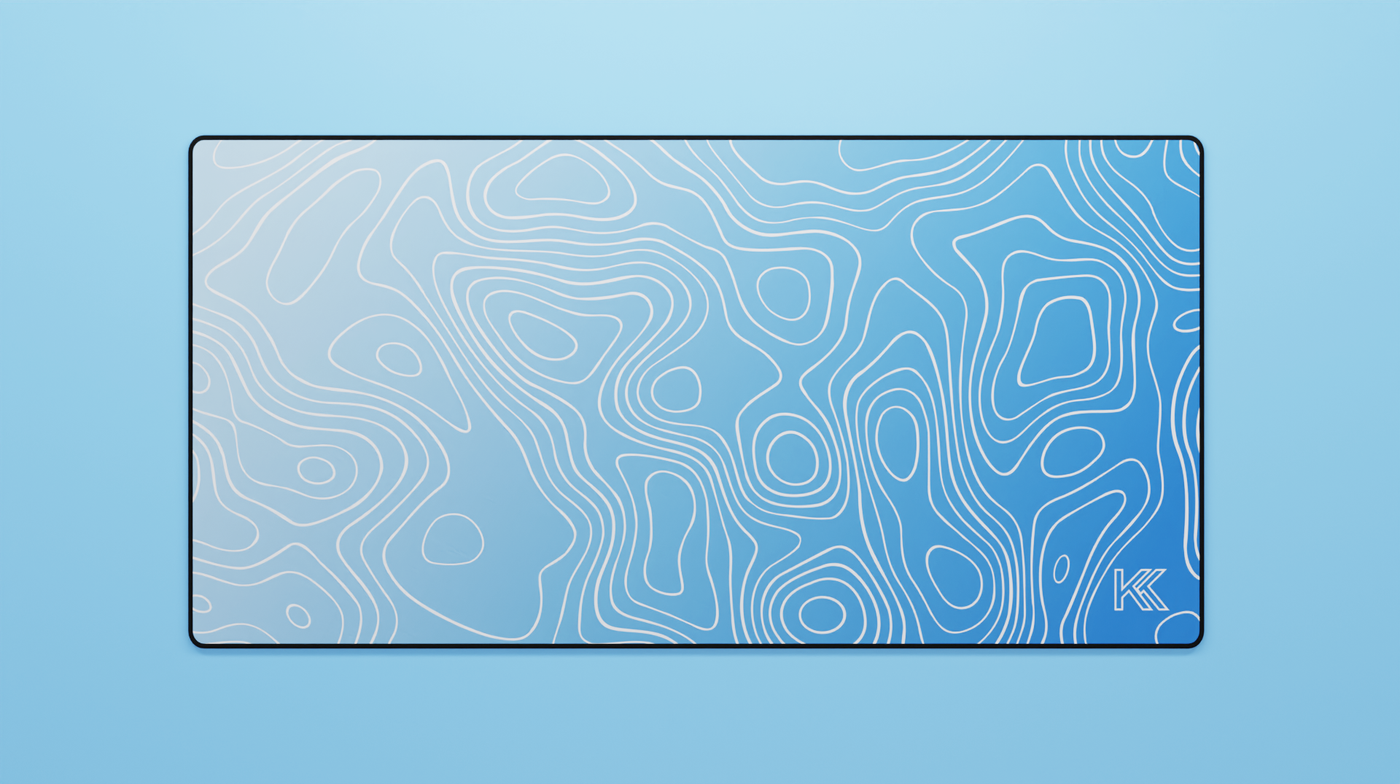 Full view of the Sapphire Topography Deskmat featuring a smooth light-to-dark blue gradient with white contour lines and black stitched edges.