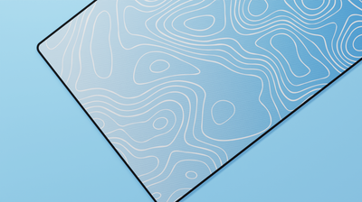 Close-up of the left side of the Sapphire Topography Deskmat highlighting soft sky-blue tones, clean topographic lines, and durable stitched edges.