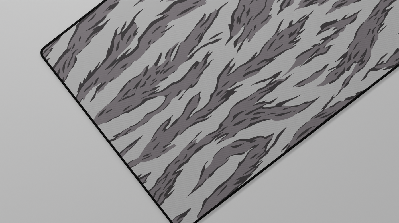Close-up of the left side of the Winter Tiger Camo Deskmat highlighting grey tiger stripes and smooth neoprene surface.